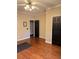 Bedroom with hardwood floors, black doors, ceiling fan, and neutral walls providing a comfortable and elegant space at 1464 Chatsworth Trace, Lawrenceville, GA 30044