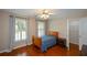 Cozy bedroom featuring hardwood floors, bright windows with blinds and an open closet at 1464 Chatsworth Trace, Lawrenceville, GA 30044