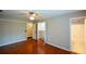 Bright bedroom with hardwood floors, ceiling fan, closet and attached bathroom at 1464 Chatsworth Trace, Lawrenceville, GA 30044