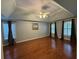Spacious bedroom with hardwood floors, a ceiling fan and three windows allowing for lots of natural light at 1464 Chatsworth Trace, Lawrenceville, GA 30044