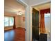 Bedroom and bathroom featuring hardwood floors, a ceiling fan and a window with curtains at 1464 Chatsworth Trace, Lawrenceville, GA 30044