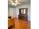 Spacious bedroom showcases a wooden dresser with mirror and hardwood floors at 1464 Chatsworth Trace, Lawrenceville, GA 30044