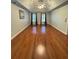 Spacious bedroom with hardwood floors, a ceiling fan and three windows allowing for lots of natural light at 1464 Chatsworth Trace, Lawrenceville, GA 30044