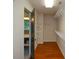 Walk-in closet with wood floors, wire shelving and access to the bathroom at 1464 Chatsworth Trace, Lawrenceville, GA 30044