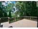 Large wooden deck overlooking a lush, green backyard with mature trees at 1464 Chatsworth Trace, Lawrenceville, GA 30044