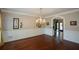 Elegant dining room featuring wainscoting, hardwood floors, and a chandelier at 1464 Chatsworth Trace, Lawrenceville, GA 30044