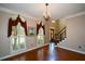 Formal dining area featuring hardwood floors and natural light pouring through the windows at 1464 Chatsworth Trace, Lawrenceville, GA 30044