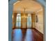 Dining room featuring elegant wainscoting, hardwood floors, and a chandelier at 1464 Chatsworth Trace, Lawrenceville, GA 30044