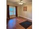 A versatile empty room with hardwood floors and large windows at 1464 Chatsworth Trace, Lawrenceville, GA 30044