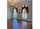 Well-lit room featuring hardwood floors, shuttered windows, and crown moulding at 1464 Chatsworth Trace, Lawrenceville, GA 30044