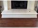 Close-up of a traditional fireplace hearth with marble tile at 1464 Chatsworth Trace, Lawrenceville, GA 30044