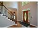 Inviting foyer featuring a staircase, wood floors, and a decorative front door with sidelights at 1464 Chatsworth Trace, Lawrenceville, GA 30044