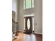 An elegant foyer with hardwood floors and a decorative front door at 1464 Chatsworth Trace, Lawrenceville, GA 30044