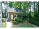 Detached brick garage with lush landscaping offering private backyard access at 1464 Chatsworth Trace, Lawrenceville, GA 30044