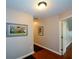 Hallway with wood floors and neutral wall color leading to other rooms at 1464 Chatsworth Trace, Lawrenceville, GA 30044