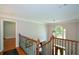 Upstairs hallway with staircase and natural light from arched window at 1464 Chatsworth Trace, Lawrenceville, GA 30044