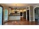 Spacious kitchen featuring white cabinets, stainless steel appliances, black countertops, and a large island at 1464 Chatsworth Trace, Lawrenceville, GA 30044