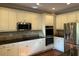 Modern kitchen featuring white cabinets, granite countertops, tile backsplash, and stainless steel appliances for a sleek look at 1464 Chatsworth Trace, Lawrenceville, GA 30044