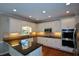 Spacious kitchen with white cabinets, dark countertops, stainless steel appliances, and stylish backsplash at 1464 Chatsworth Trace, Lawrenceville, GA 30044
