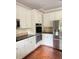 Well-appointed kitchen with white cabinets, granite counters, tiled backsplash, and stainless steel appliances, offering style and functionality at 1464 Chatsworth Trace, Lawrenceville, GA 30044