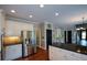 Elegant kitchen with stainless steel refrigerator, granite counters, and view into the adjacent rooms at 1464 Chatsworth Trace, Lawrenceville, GA 30044