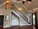 Living area boasts staircase with dark railings and built-in cabinets underneath at 1464 Chatsworth Trace, Lawrenceville, GA 30044
