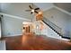 Open concept living room featuring hardwood floors, staircase, and ample natural light at 1464 Chatsworth Trace, Lawrenceville, GA 30044