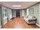 Inviting living room featuring wood-look flooring, neutral paint, and natural light from the windows at 1464 Chatsworth Trace, Lawrenceville, GA 30044