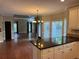 Open-concept living space with hardwood floors, kitchen island and plentiful natural light offering a welcoming and airy feel at 1464 Chatsworth Trace, Lawrenceville, GA 30044