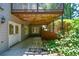 Covered outdoor patio area offers respite from the sun, plus mature landscaping at 1464 Chatsworth Trace, Lawrenceville, GA 30044