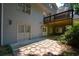 Covered outdoor patio area features stone walkway and mature landscaping at 1464 Chatsworth Trace, Lawrenceville, GA 30044