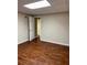 Neutral room featuring wood-look flooring and a doorway to another room at 1464 Chatsworth Trace, Lawrenceville, GA 30044
