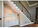Staircase with carpet runner and custom cabinet under the stairs at 1464 Chatsworth Trace, Lawrenceville, GA 30044