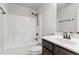 Bathroom featuring white tub and shower combination, a dark vanity and white toilet at 162 Aylesbury Blvd, Mcdonough, GA 30252