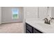 Bathroom featuring a vanity with dark cabinetry and an ornate faucet with a view into the bedroom at 162 Aylesbury Blvd, Mcdonough, GA 30252