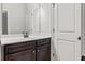 Bathroom showcasing a dark wooden vanity and a well-lit mirror at 162 Aylesbury Blvd, Mcdonough, GA 30252