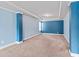 Spacious carpeted bedroom with blue accent walls, recessed ceiling and a window at 162 Aylesbury Blvd, Mcdonough, GA 30252