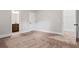 Bright room featuring neutral carpeting, paint, and trim at 162 Aylesbury Blvd, Mcdonough, GA 30252