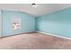 Bedroom featuring light blue walls, neutral carpet and a window providing natural light at 162 Aylesbury Blvd, Mcdonough, GA 30252