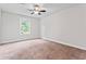 Bedroom with neutral walls, carpet and a window allowing natural light to fill the space at 162 Aylesbury Blvd, Mcdonough, GA 30252