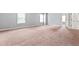 Bedroom with gray walls and carpet plus two windows and a doorway to another room at 162 Aylesbury Blvd, Mcdonough, GA 30252