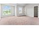 Bedroom featuring gray walls and carpet along with large windows and a walk in closet at 162 Aylesbury Blvd, Mcdonough, GA 30252