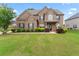 Inviting two-story brick home with manicured lawn and mature landscaping at 162 Aylesbury Blvd, Mcdonough, GA 30252