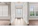 Bright foyer with hardwood floors and views into adjacent living spaces at 162 Aylesbury Blvd, Mcdonough, GA 30252
