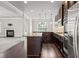 Open-concept kitchen featuring stainless steel appliances, granite counters, and dark wood floors at 162 Aylesbury Blvd, Mcdonough, GA 30252