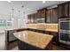 Spacious kitchen with stainless steel appliances, granite counters, and dark wood cabinetry at 162 Aylesbury Blvd, Mcdonough, GA 30252