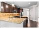 Spacious kitchen with stainless steel appliances, granite countertops and dark wood cabinets at 162 Aylesbury Blvd, Mcdonough, GA 30252