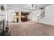 Open-concept living room with view into kitchen and stairway at 162 Aylesbury Blvd, Mcdonough, GA 30252