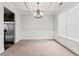 Traditional living room with neutral walls, carpet, decorative molding, and stainless steel appliances at 162 Aylesbury Blvd, Mcdonough, GA 30252