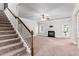 Comfortable carpeted living room with staircase, fireplace, and access to the outdoors at 162 Aylesbury Blvd, Mcdonough, GA 30252